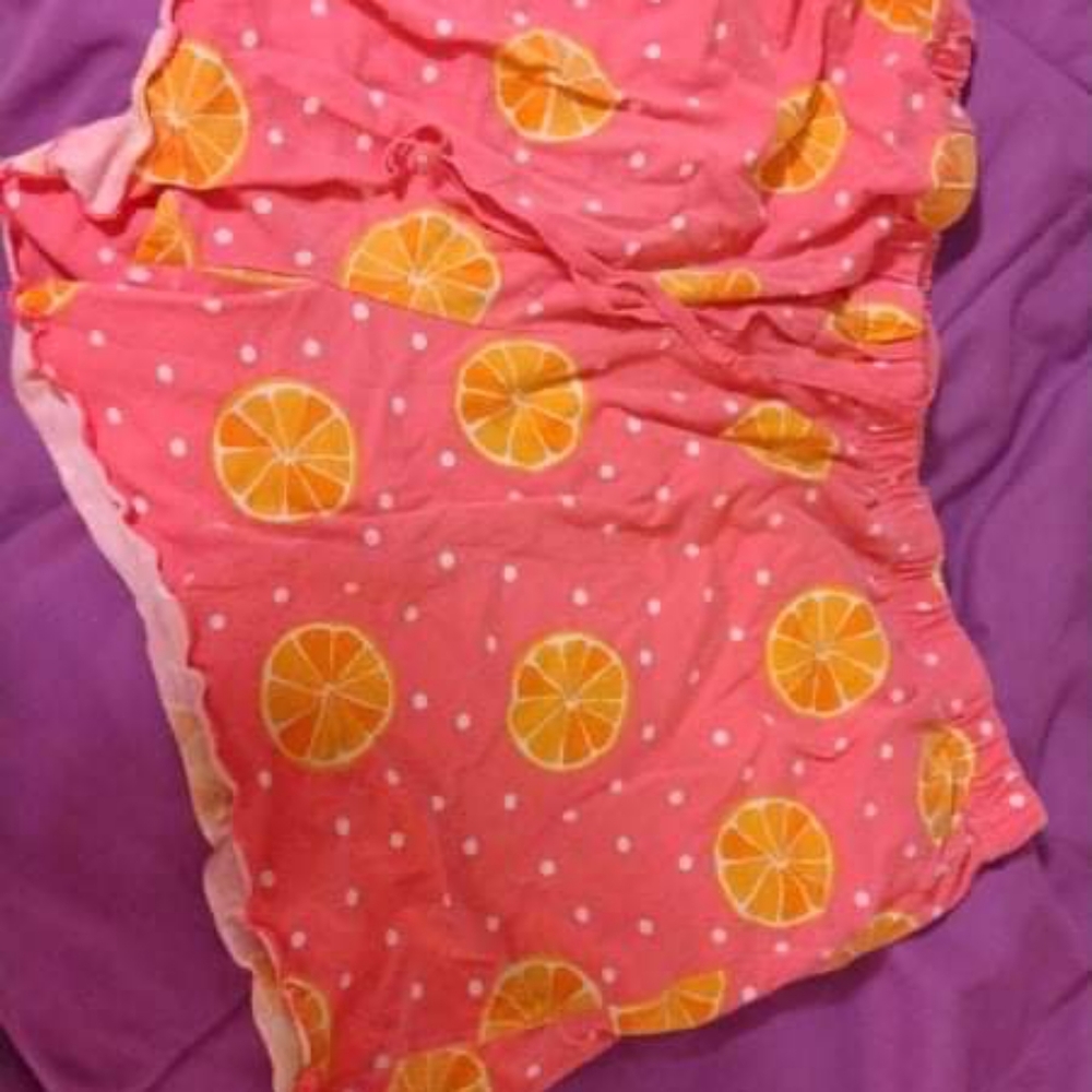 Pink PJ shorts with orange print size Medium(8-10)